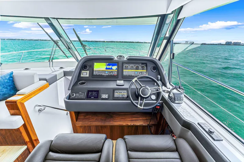 Slide: The Image of 2024 Riviera 505 SUV yacht helm with advanced navigation systems and ocean view. - 42