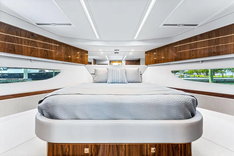 Slide: The Image of Luxurious bedroom interior of 2024 Riviera 505 SUV yacht with modern design and wood accents. - 45