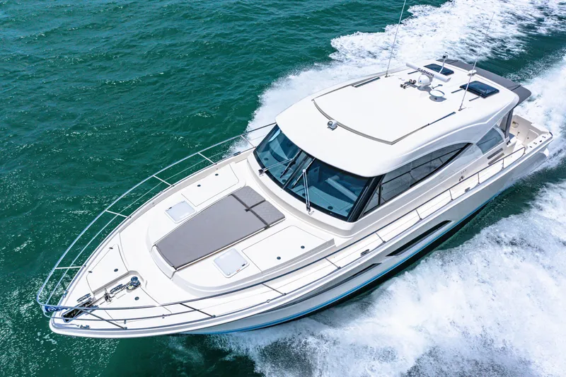 Slide: The Image of 2024 Riviera 505 SUV luxury yacht cruising on open water. - 9