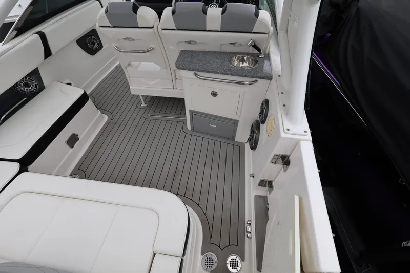 Slide: The Image of 2022 Chaparral 280 OSX boat interior with seating, sink, and modern design. - 10