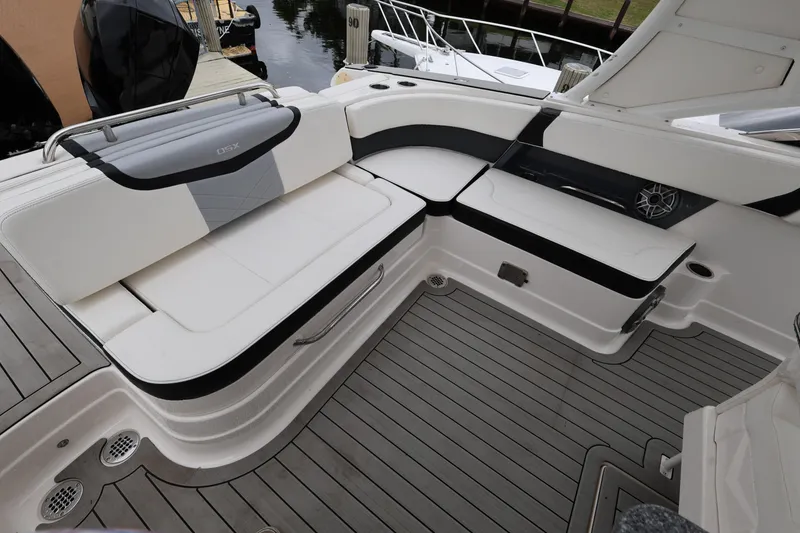 Slide: The Image of 2022 Chaparral 280 OSX boat interior with sleek seating and modern design. - 11