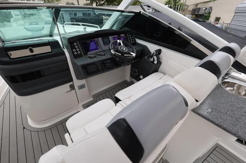 Slide: The Image of 2022 Chaparral 280 OSX boat cockpit with modern controls and seating. - 12