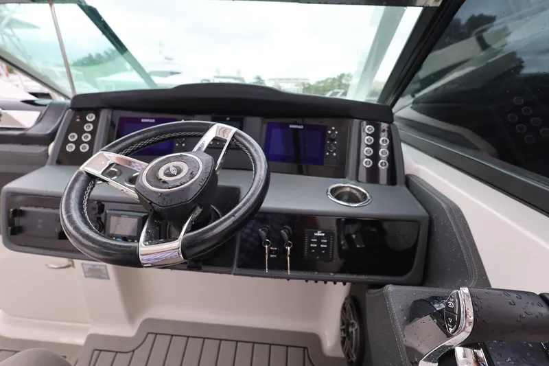 Slide: The Image of 2022 Chaparral 280 OSX helm with modern controls and sleek steering wheel design. - 13