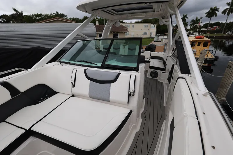Slide: The Image of 2022 Chaparral 280 OSX boat interior with sleek seating and modern design. - 17