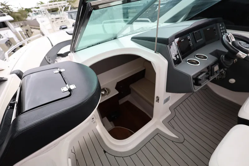 Slide: The Image of 2022 Chaparral 280 OSX boat cockpit with modern controls and seating. - 19