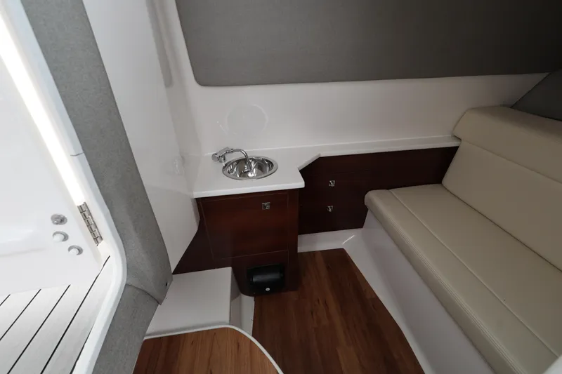 Slide: The Image of 2022 Chaparral 280 OSX cabin interior with sink and seating area. - 20