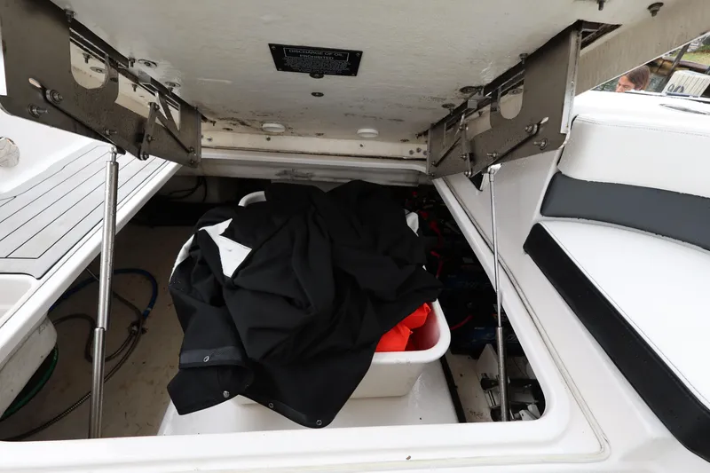 Slide: The Image of 2022 Chaparral 280 OSX storage compartment with black and orange items inside. - 23