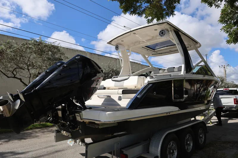 Slide: The Image of 2022 Chaparral 280 OSX boat on trailer, featuring sleek design and powerful outboard engines. - 5