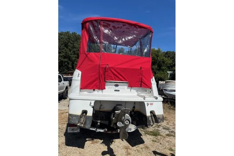 Slide: The Image of 2000 Four Winns 238 Vista boat with red canopy, rear view. - 15