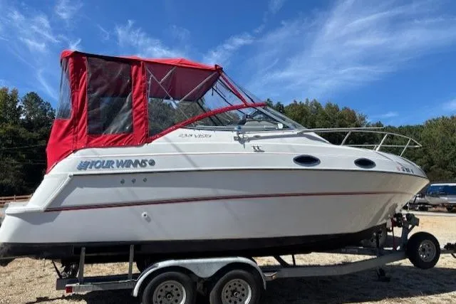 Slide: The Image of 2000 Four Winns 238 Vista boat with red canopy on a trailer. - 16