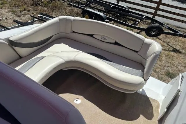 Slide: The Image of 2000 Four Winns 238 Vista boat interior with curved seating and beige upholstery. - 18