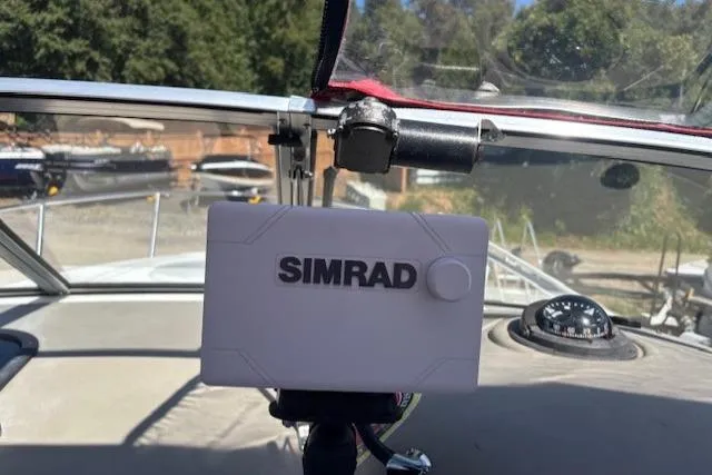 Slide: The Image of Simrad navigation system on 2000 Four Winns 238 Vista boat dashboard. - 24