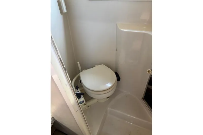 Slide: The Image of Compact marine toilet in 2000 Four Winns 238 Vista boat bathroom. - 26