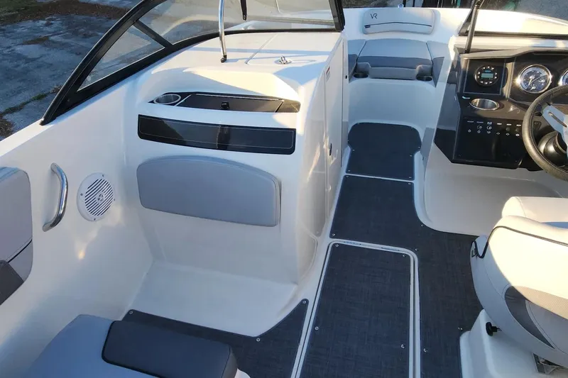 Slide: The Image of 2022 Bayliner VR6 Bowrider OB interior with modern dashboard and seating. - 13