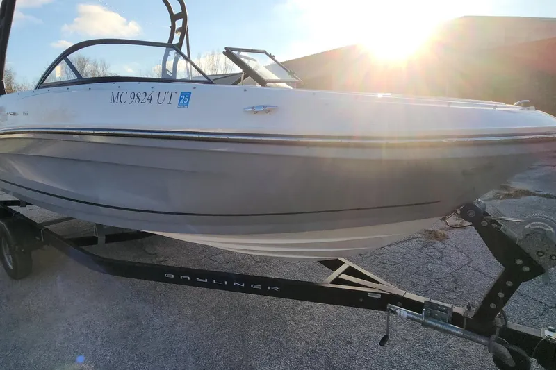 Slide: The Image of 2022 Bayliner VR6 Bowrider OB on trailer, sunlit background. - 22