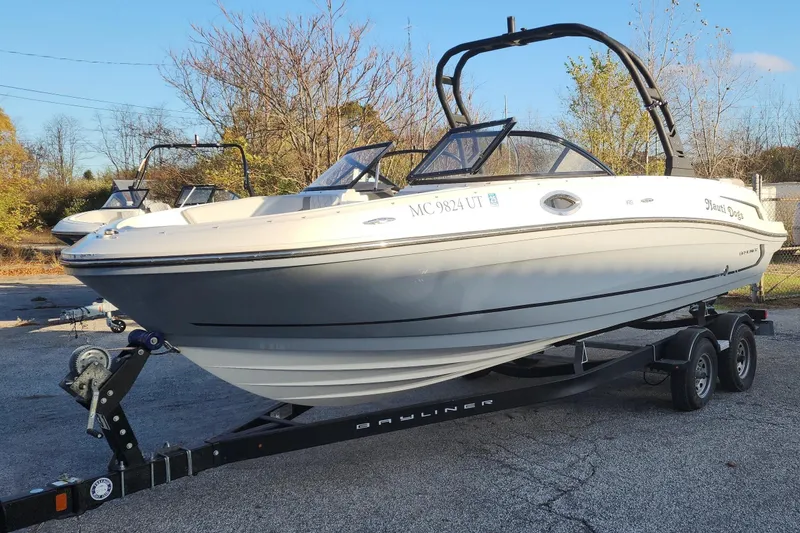 Slide: The Image of 2022 Bayliner VR6 Bowrider OB on trailer, parked outdoors, showcasing sleek design. - 27