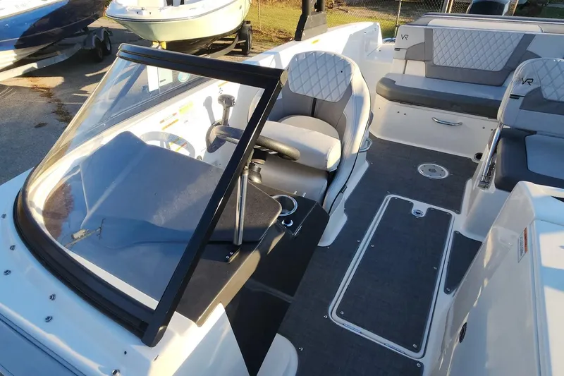 Slide: The Image of 2022 Bayliner VR6 Bowrider OB interior with seating and steering console. - 4