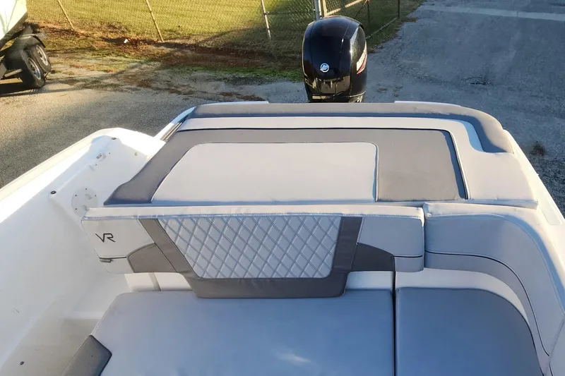 Slide: The Image of 2022 Bayliner VR6 Bowrider OB with cushioned seating and outboard motor. - 9