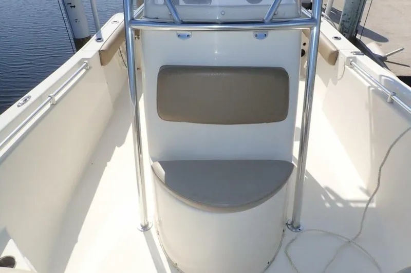 Slide: The Image of 2023 Cobia 217 CC boat interior with seating and stainless steel railings. - 18