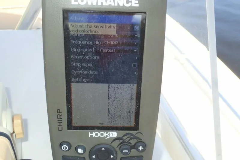 Slide: The Image of Lowrance HOOK-4x fishfinder on 2023 Cobia 217 CC boat dashboard. - 21