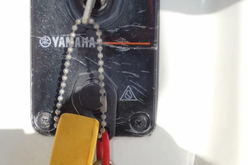 Slide: The Image of Close-up of a Yamaha ignition switch on a 2023 Cobia 217 CC boat. - 29