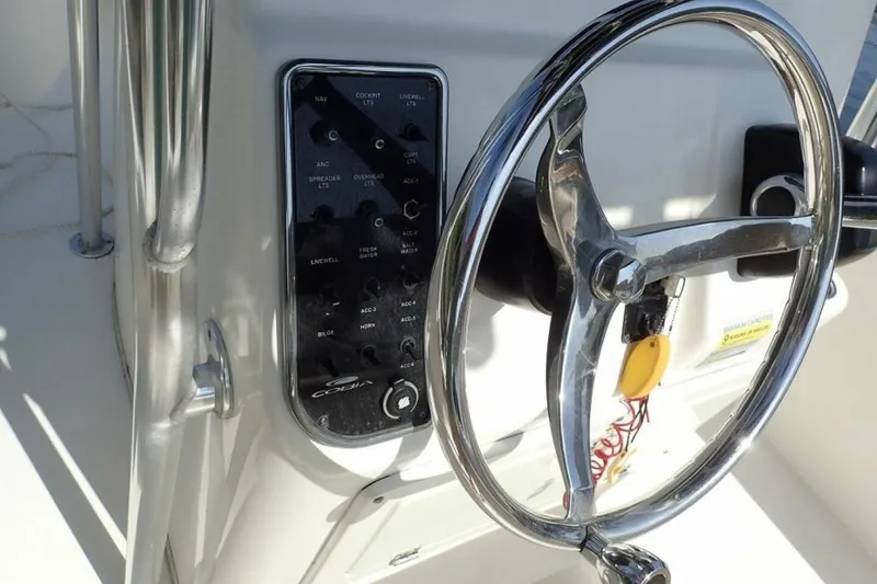 Slide: The Image of Steering wheel and control panel of 2023 Cobia 217 CC boat. - 30