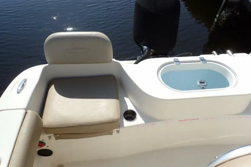 Slide: The Image of 2023 Cobia 217 CC boat interior with seating and livewell. - 32