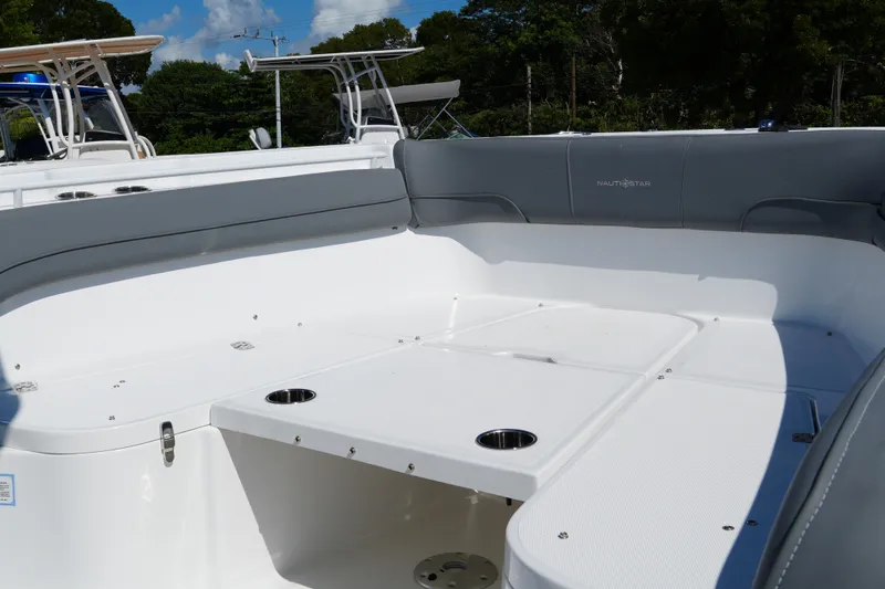 Slide: The Image of 2025 NauticStar 292 Legacy boat interior with spacious seating and cup holders. - 12