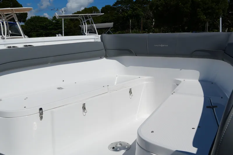 Slide: The Image of 2025 NauticStar 292 Legacy boat interior with spacious seating and storage compartments. - 15