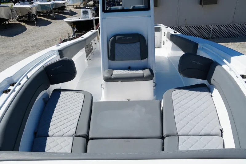 Slide: The Image of 2025 NauticStar 292 Legacy boat interior with gray cushioned seating and modern design. - 17