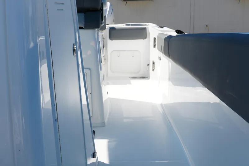 Slide: The Image of 2025 NauticStar 292 Legacy boat interior, showcasing sleek white deck and seating. - 19
