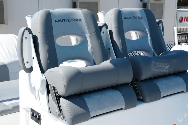 Slide: The Image of 2025 NauticStar 292 Legacy boat seats with gray upholstery and armrests. - 21