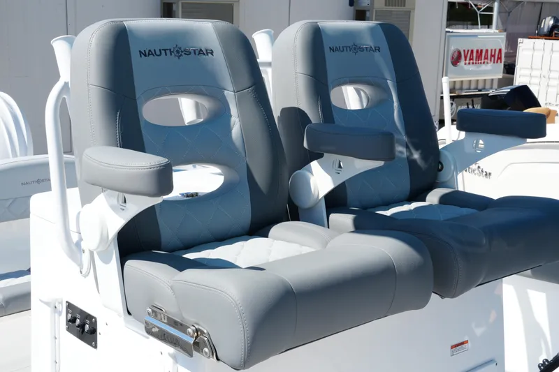 Slide: The Image of Luxury seating on 2025 NauticStar 292 Legacy boat, featuring plush gray upholstery. - 22