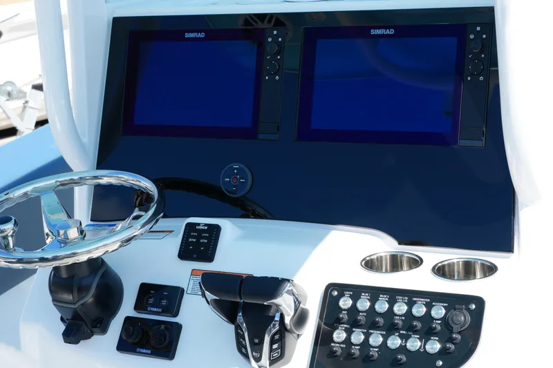Slide: The Image of 2025 NauticStar 292 Legacy boat dashboard with dual Simrad displays and control panel. - 23