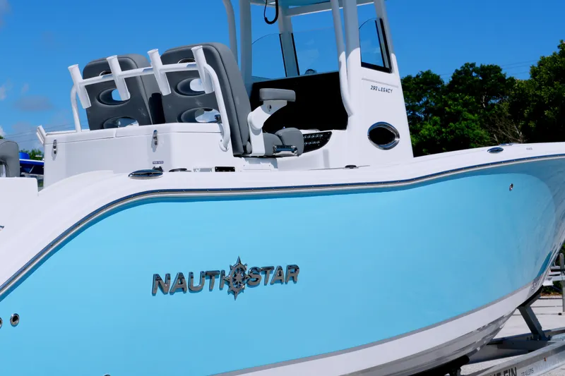 Slide: The Image of 2025 NauticStar 292 Legacy boat with sleek blue hull and modern design. - 3