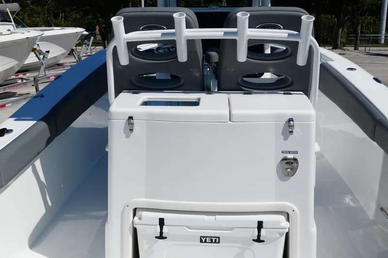 Slide: The Image of 2025 NauticStar 292 Legacy boat interior with rod holders and Yeti cooler. - 30