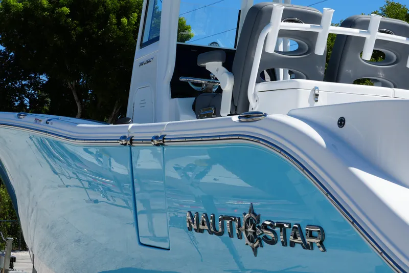 Slide: The Image of 2025 NauticStar 292 Legacy boat with sleek blue hull and modern design. - 4