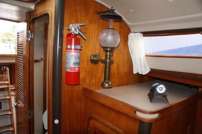 Slide: The Image of Interior of 1982 C&C Landfall 35 sailboat with vintage lamp and fire extinguisher. - 10