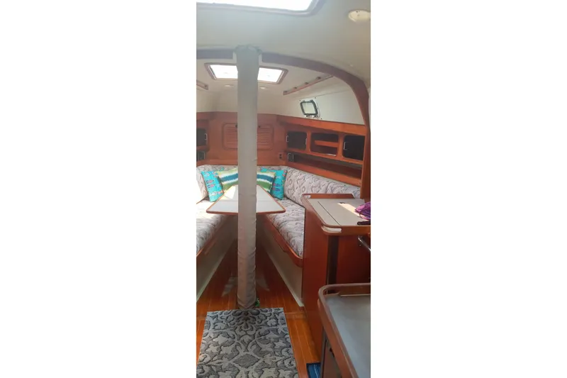 Slide: The Image of Interior of 1982 C&C Landfall 35 sailboat with cozy seating and wooden finishes. - 5