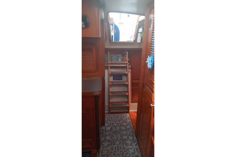 Slide: The Image of Interior of 1982 C&C Landfall 35 sailboat with wooden cabinetry and ladder. - 6