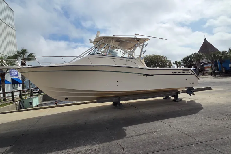 The Image of 2013 Grady-White Express 330 boat on a dock, clear sky background. - 1