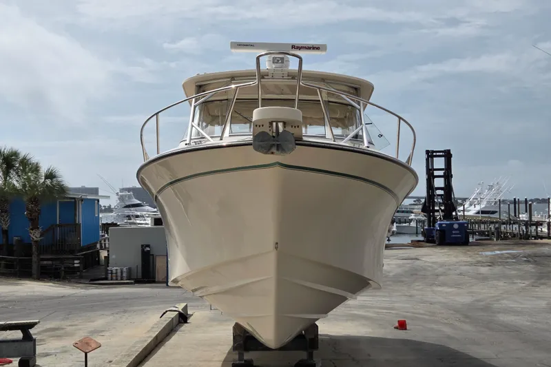 Slide: The Image of 2013 Grady-White Express 330 boat on dry dock, marina background. - 3