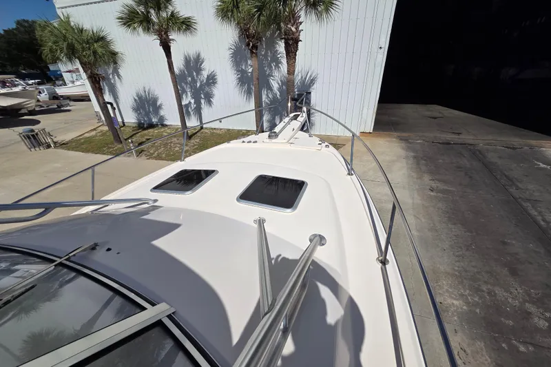 Slide: The Image of 2013 Grady-White Express 330 boat deck with palm trees and storage building. - 5