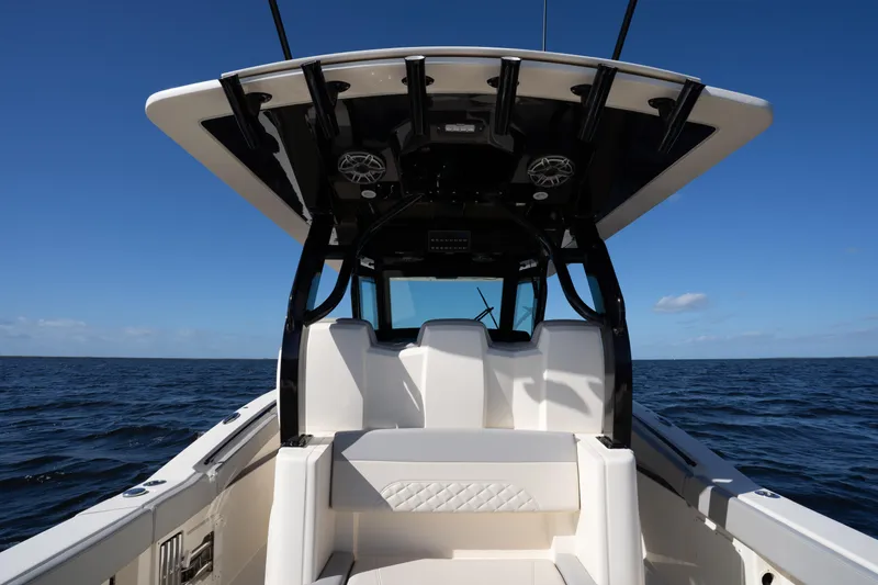 Slide: The Image of 2024 Scout 330 LXF boat interior with ocean backdrop under clear blue sky. - 22