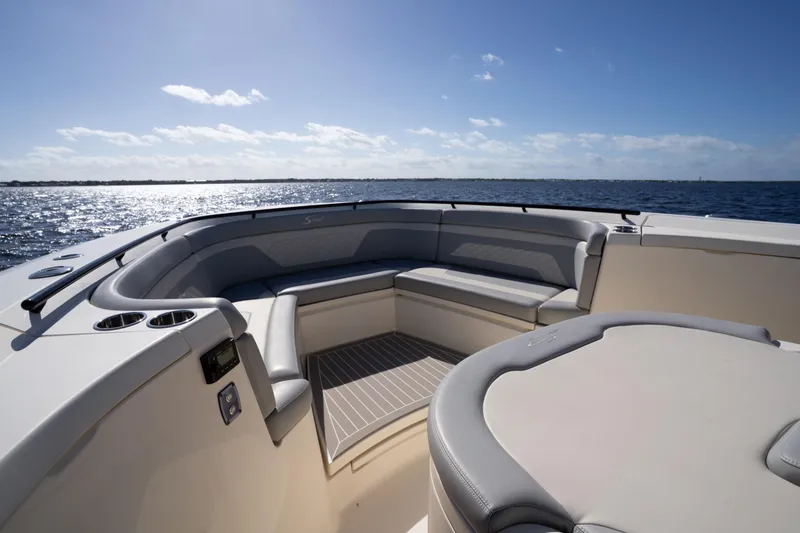 Slide: The Image of 2024 Scout 330 LXF boat interior with luxurious seating, ocean view, and clear sky. - 24
