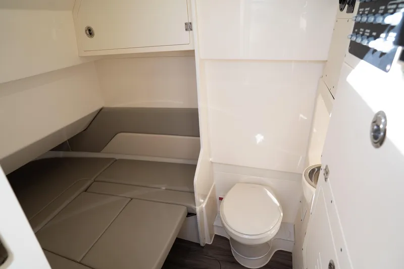 Slide: The Image of 2024 Scout 330 LXF cabin interior with bed and toilet, featuring modern design and amenities. - 31