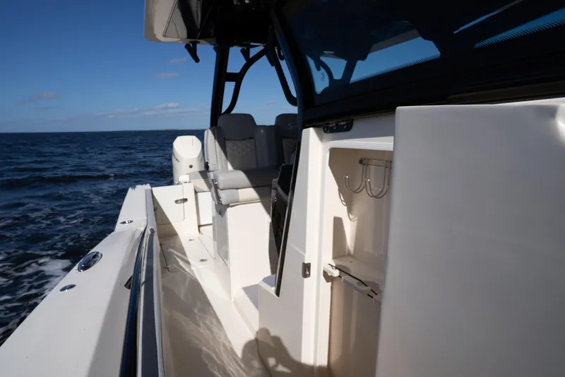 Slide: The Image of 2024 Scout 330 LXF boat interior with seating and ocean view. - 35