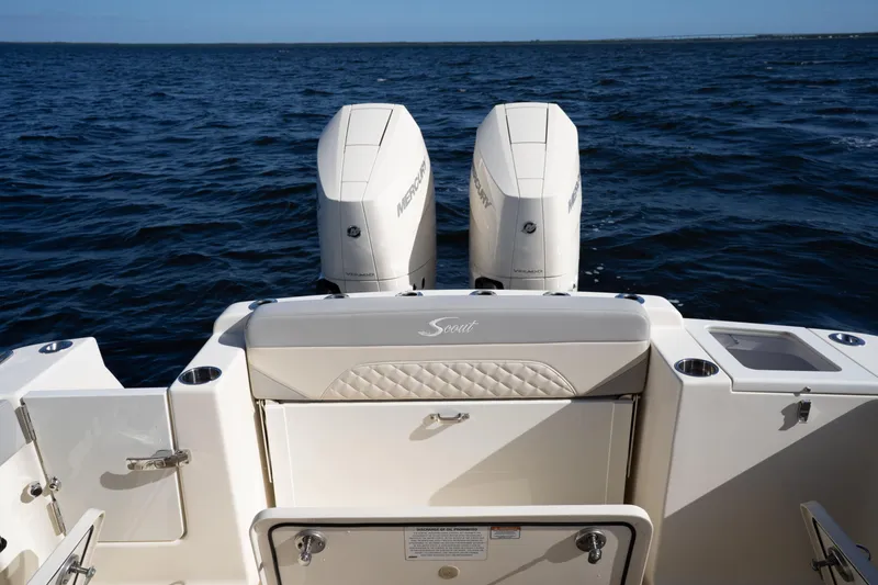 Slide: The Image of 2024 Scout 330 LXF boat with dual Mercury engines on open water. - 36