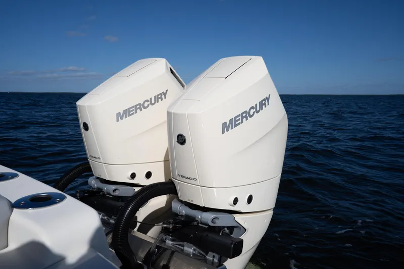 Slide: The Image of Twin Mercury Verado engines on a 2024 Scout 330 LXF boat in open water. - 37