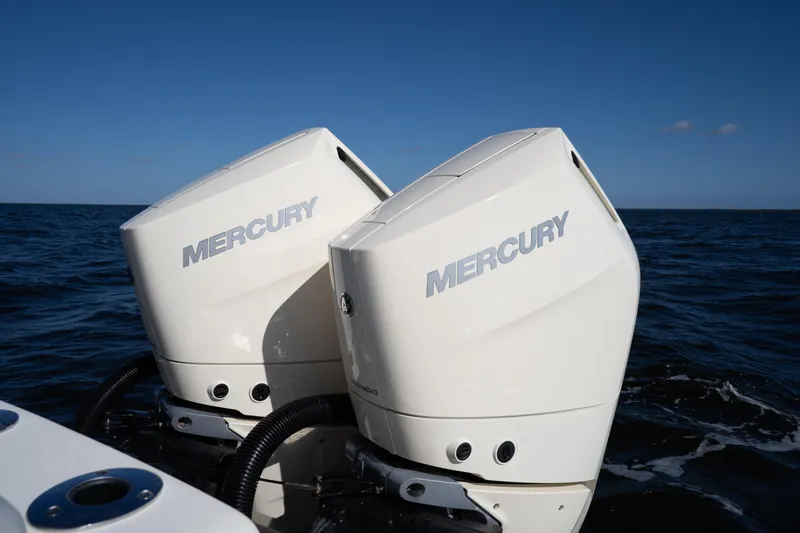 Slide: The Image of 2024 Scout 330 LXF with dual Mercury outboard engines on open water. - 38